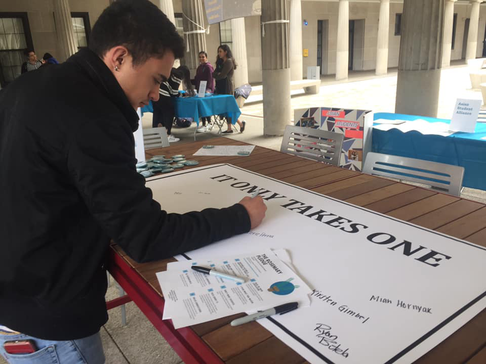 Student Signing Bystander Pledge