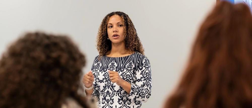 Instructor teaching at the front of a classroom