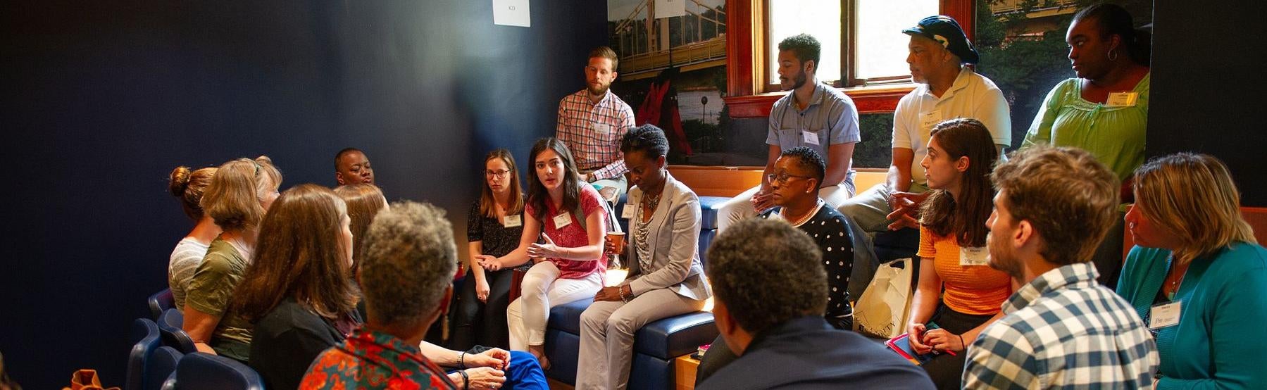 Image of students, faculty, and staff discussing issues in a group setting